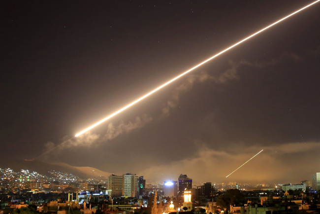 Damascus skies erupt with surface to air missile fire as the U.S. launches an attack on Syria targeting different parts of the Syrian capital Damascus, Syria, early Saturday, April 14, 2018. [Photo: AP/Hassan Ammar]