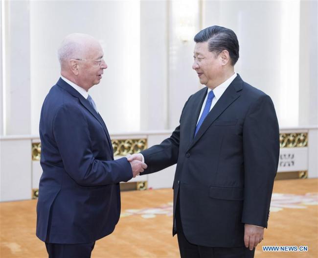 Chinese President Xi Jinping (Right) meets with Klaus Schwab, founder and executive chairman of the World Economic Forum (WEF), in Beijing, capital of China, April 16, 2018. [Photo: Xinhua/Li Tao]