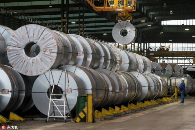 A worker stores steel collies from the Salzgitter AG in Salzgitter, Germany, March 22, 2018. [Photo: IC]