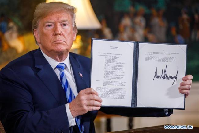 U.S. President Donald Trump signs a memorandum declaring his intention to withdraw from Iranian nuke deal at the White House in Washington D.C., the U.S., on May 8, 2018. [Photo: Xinhua]