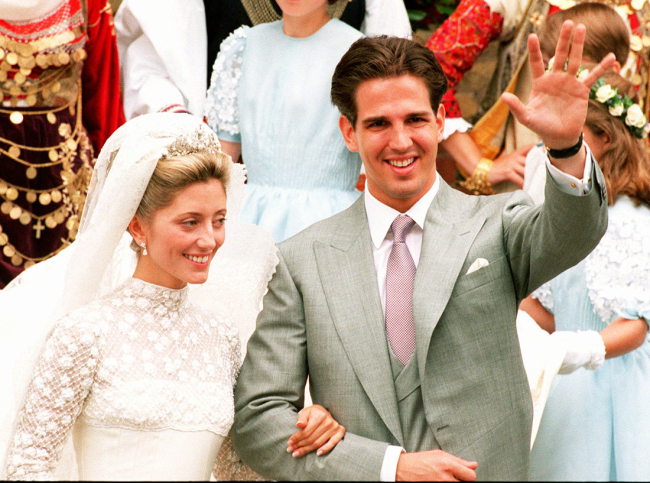 Crown Prince Pavlos of Greece waves to crowds of well-wishers with his bride Marie-Chantal Miller as they leave the Greek cathedral in West London on July 1, 1995. [File Photo: AP/Alistair Grant]
