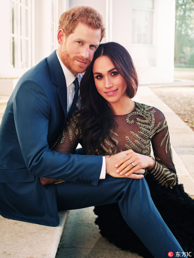 A picture released on December 21, 2017 by Kensington Palace shows Britain's Prince Harry posing with his fiancée U.S. actress Meghan Markle at Frogmore House in Windsor. [Photo: IC]