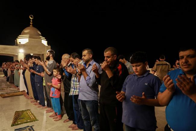 Palestinian worshippers perform "Taraweeh" prayer on the first evening of the holy month of Ramadan in Gaza City, on May 17, 2018. 