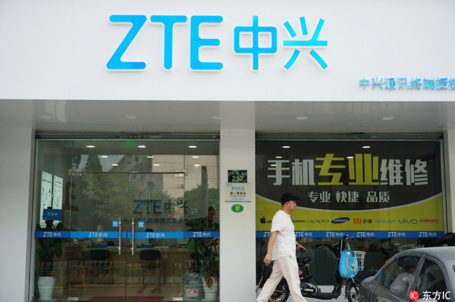 A pedestrian walks past a store of ZTE in Hangzhou city, east China's Zhejiang province, May 14 2018. [Photo: IC]