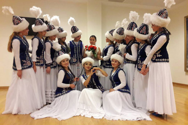 Musicians from Kyrgyzstan who perform at the Shanghai Cooperation Organization in Beijing take a group photo. [Photo: China Plus]