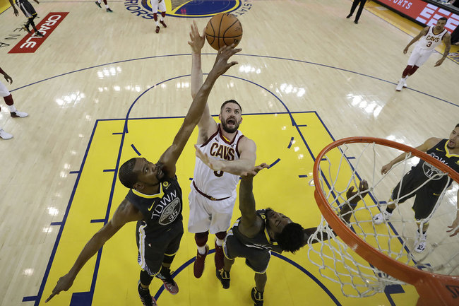 Cleveland Cavaliers forward Kevin Love, center, shoots between Golden State Warriors forward Kevin Durant (35) and forward Jordan Bell during the first half of Game 2 of basketball's NBA Finals in Oakland, Calif., Sunday, June 3, 2018. [Photo: AP]