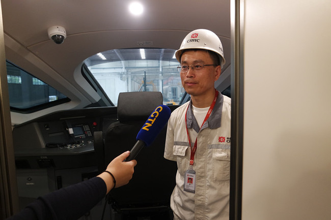 Zhang Fangtao, a major designer of the high speed train model CR400AF receives interview with CGTN, at CRRC Qingdao Sifang manufacturing base, The Bullet Train Town, Qingdao, June 8th, 2018. [Photo: China Plus]