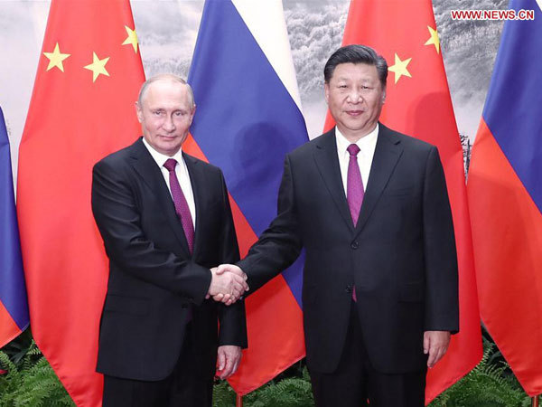 Chinese President Xi Jinping (Right) holds talks with his Russian counterpart Vladimir Putin in Beijing, capital of China, June 8, 2018. [Photo: Xinhua/Ju Peng]