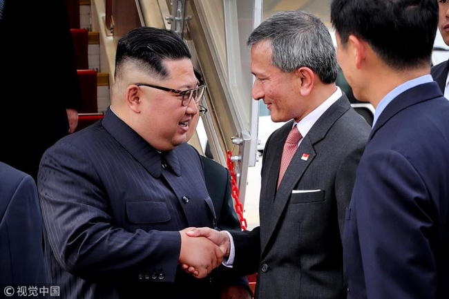 This photo captured from the Facebook of Singaporean Foreign Minister Vivian Balakrishnan on June 10, 2018, shows North Korean leader Kim Jong-un (L) welcomed by the minister upon arriving at Changi Airport in Singapore. Kim is visiting the island country to hold a summit with U.S. President Donald Trump on June 12. [Photo: VCG/Yonhap]