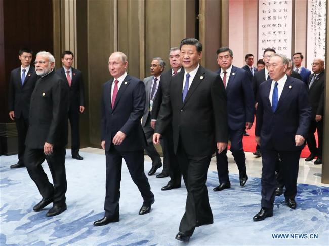 Chinese President Xi Jinping (1st R, front) and other leaders of Shanghai Cooperation Organization (SCO) member states attend a restricted session of the 18th SCO summit in Qingdao, east China's Shandong Province, June 10, 2018. Chinese President Xi Jinping on Sunday chaired a restricted session of the 18th SCO summit in east China's coastal city of Qingdao. [Photo: Xinhua/Ding Lin]