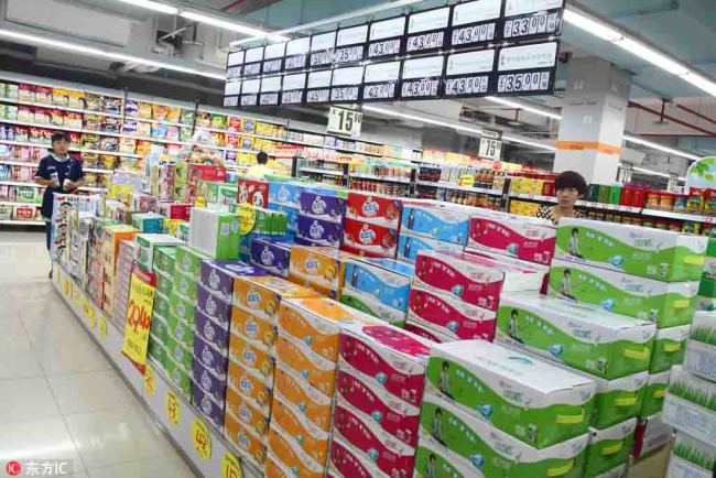 Cartons of milk are for sale at a supermarket. [File photo: IC]