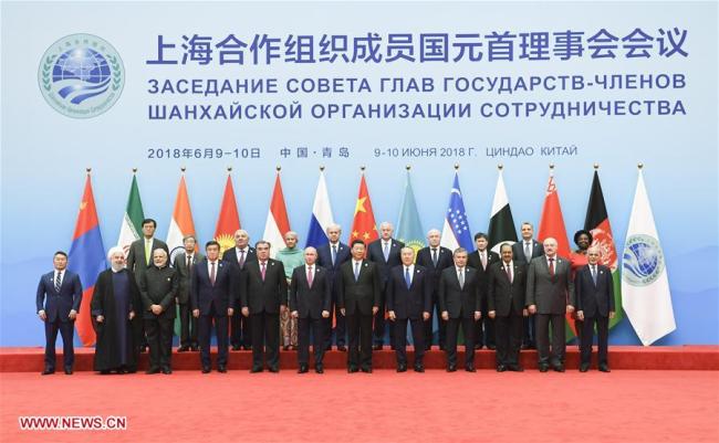 Chinese President Xi Jinping (6th R, front) poses for a group photo with other leaders and guests ahead of the 18th Meeting of the Council of Heads of Member States of the Shanghai Cooperation Organization (SCO) in Qingdao, east China's Shandong Province, June 10, 2018.[Photo: Xinhua]