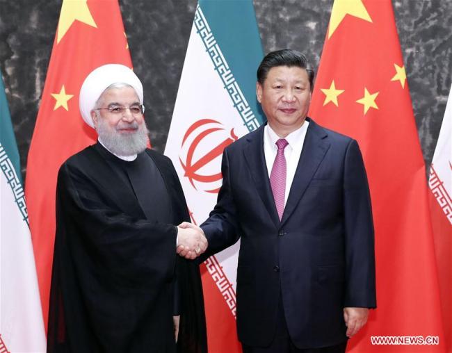 Chinese President Xi Jinping (R) holds talks with his Iranian counterpart Hassan Rouhani in Qingdao, east China's Shandong Province, June 10, 2018. [Photo: Xinhua] 