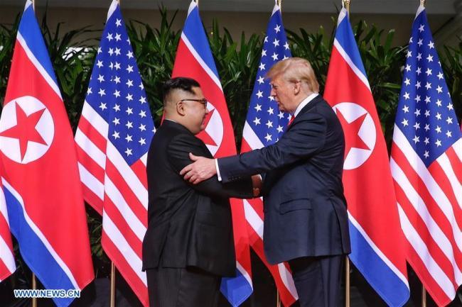 Top leader of the Democratic People's Republic of Korea (DPRK) Kim Jong Un (L) shakes hands with U.S. President Donald Trump in Singapore before the first-ever DPRK-U.S. summit, on June 12, 2018. [Photo: Xinhua/The Straits Times]