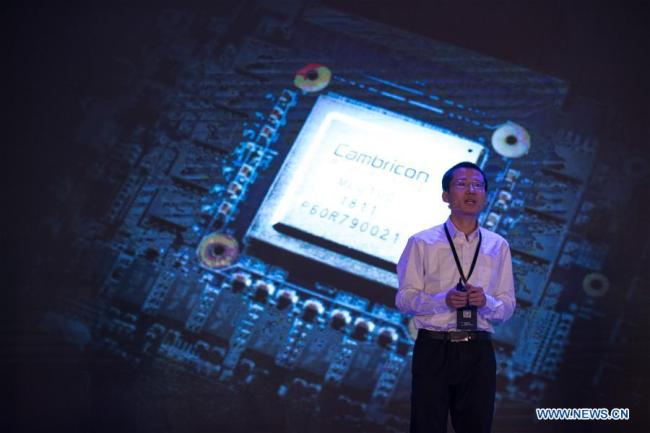 Cambricon Technology CEO Chen Tianshi introduces the cloud AI chip MLU100 in Shanghai on May 3, 2018. [File photo: Xinhua]