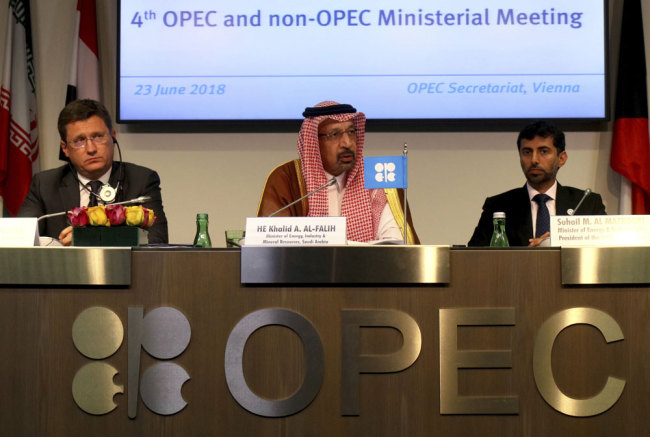 Russian Minister of Energy Alexander Novak, Khalid Al-Falih Minister of Energy, Industry and Mineral Resources of Saudi Arabia and Minister of Energy of the United Arab Emirates, UAE, Suhail Mohamed Al Mazrouei, from left, attend a news conference after a meeting of the Organization of the Petroleum Exporting Countries, OPEC, and non OPEC members at their headquarters in Vienna, Austria, Saturday, June 23, 2018. [Photo: AP/Ronald Zak]