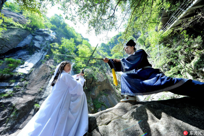 On May 18, 2017, two martial arts lovers dress up as disciples of the Quanzhen Sect from the novel "Legends of the Condor Heroes" in Wuyuan County of China's Jiangxi Province. [Photo:IC]