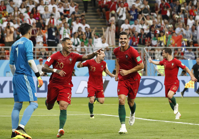 Portugal's Ricardo Quaresma, second left, celebrates scoring his team's opening goal along with teammate Portugal's Andre Silva during the group B match between Iran and Portugal at the 2018 soccer World Cup at the Mordovia Arena in Saransk, Russia, Monday, June 25, 2018. [Photo: AP]