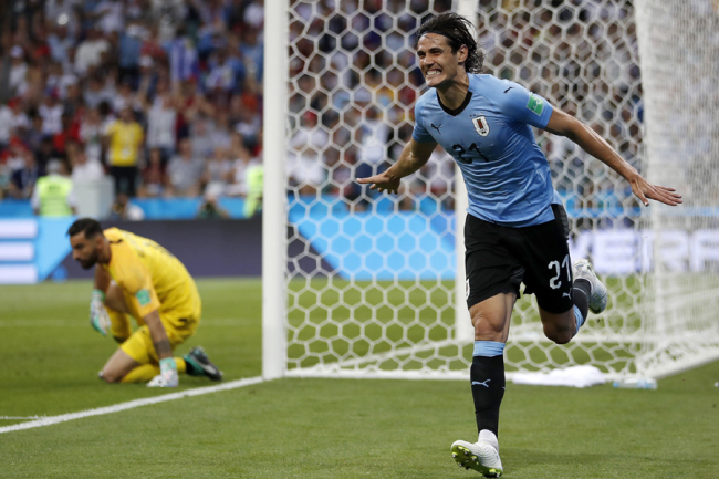 Uruguay's Edinson Cavani celebrates after he scored the opening goal during the round of 16 match between Uruguay and Portugal at the 2018 soccer World Cup at the Fisht Stadium in Sochi, Russia, Saturday, June 30, 2018. [Photo: AP]
