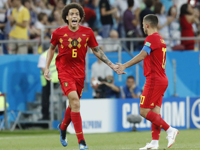 Axel Witsel celebrates with teammate Eden Hazard after Jan Vertonghen scored Belgium's opening goal during the round of 16 match between Belgium and Japan at the 2018 soccer World Cup in the Rostov Arena, in Rostov-on-Don, Russia, Monday, July 2, 2018. [Photo: AP/Pavel Golovkin]