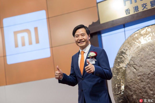 Lei Jun, chairman and CEO of Xiaomi, gestures during the company's trading debut on the Hong Kong Exchange and Clearings in Hong Kong, China, 09 July 2018.[Photo: IC]