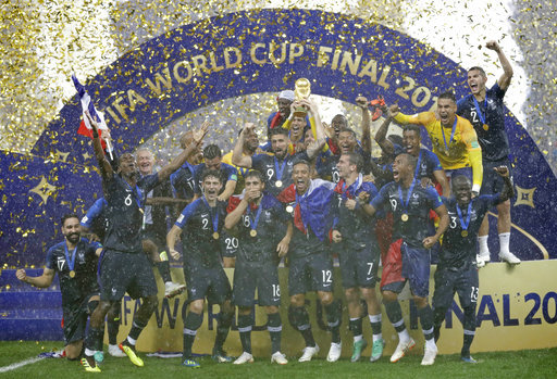 France goalkeeper Hugo Lloris holds the trophy aloft as he celebrates with his teammates after the final match between France and Croatia at the 2018 soccer World Cup in the Luzhniki Stadium in Moscow, Russia, Sunday, July 15, 2018. France won the final 4-2. [Photo: AP/Matthias Schrader]