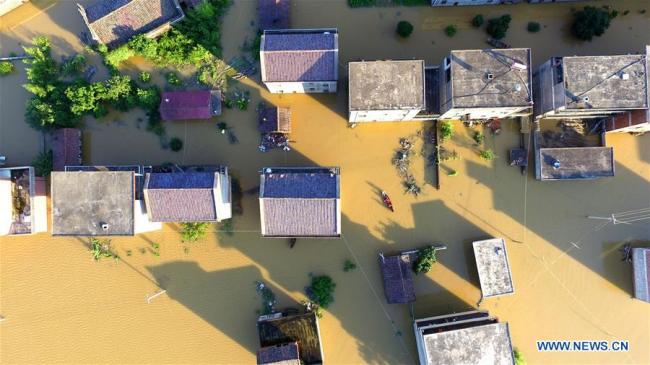 Aerial photo taken on July 8, 2018 shows the flooded area in Qiaoxi Village of Maxu Township of Fuzhou City, east China's Jiangxi Province. Flood caused by heavy rain damaged crops and housings in Maxu Township and rescue groups were set up to help the affected people. [Photo: Xinhua/He Jianghua]