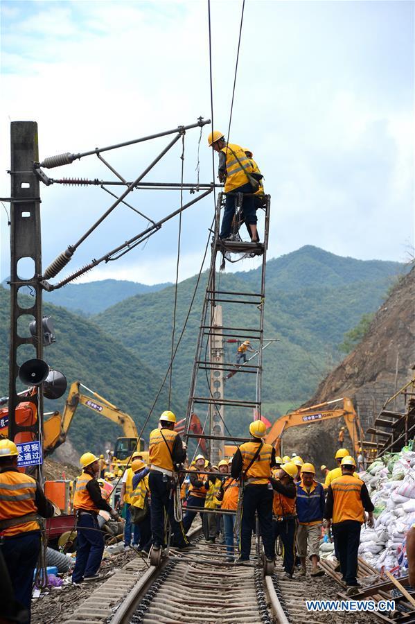 Rescuers work at the accident site in a section of the Baoji-Chengdu railway caused by rain-triggered landslides in Lueyang County, northwest China's Shaanxi Province, July 28, 2018. [Photo: Xinhua]