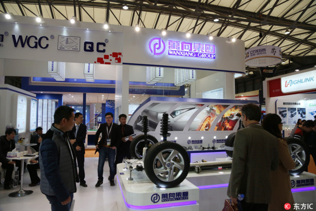 People visit the stand of Wanxiang Group during the 2014 Automechanika Shanghai (AMS) exhibition in Shanghai,December 9, 2014. [Photo: IC]