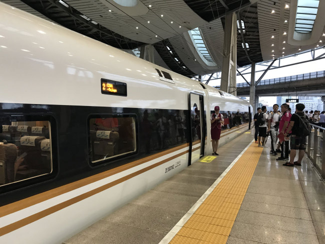 A Fuxing bullet train bound for Tianjin stops at the Beijing South Station on August 8, 2018. It will run at an increased speed of 350 km/h. [Photo: China Plus/ Li Jin]