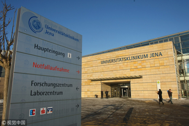People stand in front of the Universitaetsklinkum Jena (University Clinic of Jena) on January 10, 2009 in Jena, Germany. [File Photo: VCG]