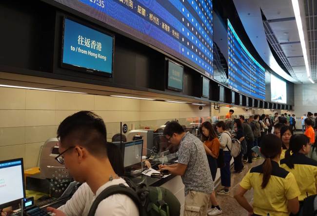 Citizens in front of counters buy tickets for the Guangzhou-Shenzhen-Hong Kong high-speed railway at the West Kowloon railway station in Hong Kong, China, September 10, 2018. [Photo: China Plus/Li Naxin]