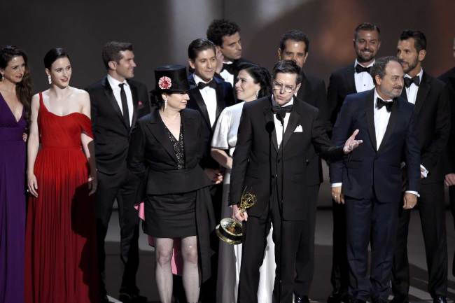Amy Sherman-Palladino, front and center left, Daniel Palladino and the cast and crew of "The Marvelous Mrs. Maisel" accept the award for outstanding comedy series at the 70th Primetime Emmy Awards on Monday, Sept. 17, 2018, at the Microsoft Theater in Los Angeles. [Photo: AP/ Chris Pizzello/Invision]