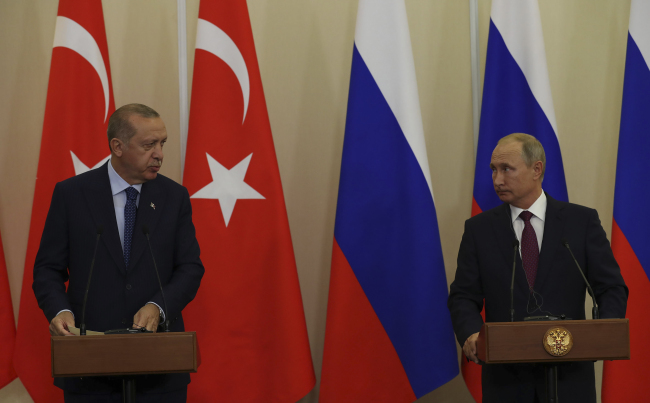 Russian President Vladimir Putin, right, listens to Turkey's President Recep Tayyip Erdogan, left, during a joint news conference following their meeting in Sochi, Russia, Monday, Sept. 17, 2018. [Photo: Presidential Press Service via AP]