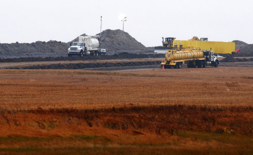 FILE - This Oct. 11, 2013, file photo shows cleanup at the site of a Tesoro Corp. pipeline break that spilled more than 20,000 barrels of oil into a Tioga, N.D., wheat field. Nearly five years after a North Dakota farmer discovered oil oozing into his wheat field, cleanup of what turned out to be a massive spill is nearly complete. It cost almost $100 million to excavate and clean the soil devastated by the pipeline break that may have been caused by a lightning strike. [Photo: AP/Kevin Cederstrom]