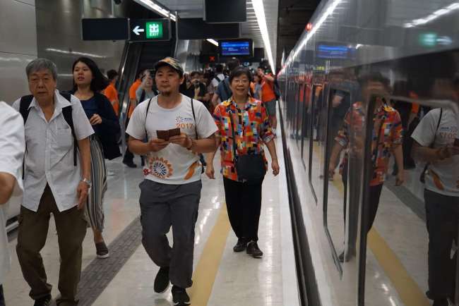 Passengers walk on a platform to take one of the first trains to Shenzhen during the first public service day of Guangzhou–Shenzhen–Hong Kong Express Rail Link (XRL) in Hong Kong on September 23, 2018. [Photo: China Plus/Li Naxin]