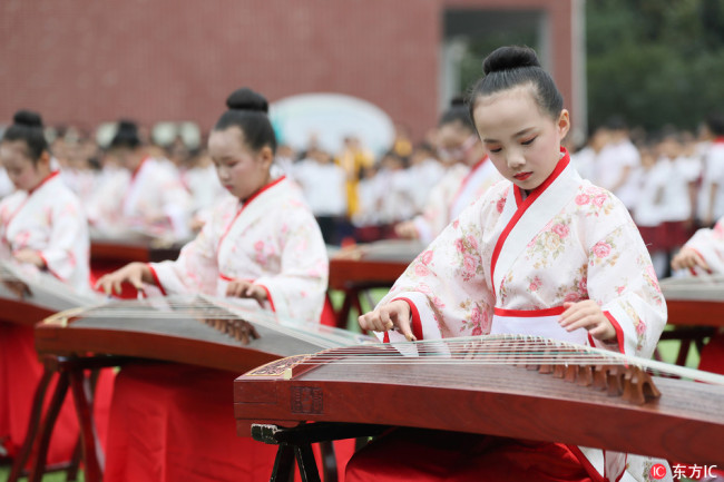 Students dressed in traditional costumes attend a ceremony to mark the 2569th anniversary of Confucius' birth at a primary school in Hengyang city, central China's Hunan province, on Friday, Sept. 28, 2018. 