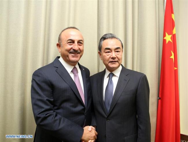 Chinese State Councilor and Foreign Minister Wang Yi (R) shakes hands with Turkish Foreign Minister Mevlut Cavusoglu during their meeting at the UN headquarters in New York, on Sept. 27, 2018. [Photo: Xinhua/Qin Lang]