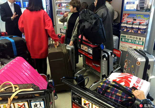 Four Chinese girls carried luggage filled with Japanese goods at the airport in Osaka, Japan on March 1, 2016. [Photo: IC]