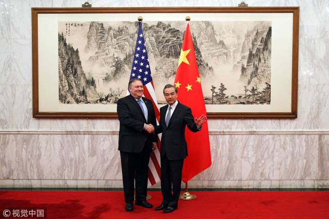 China's State Councillor and Foreign Minister Wang Yi shakes hands with US Secretary of State Mike Pompeo at the Diaoyutai State Guesthouse in Beijing, China, October 8, 2018. [Photo: VCG]