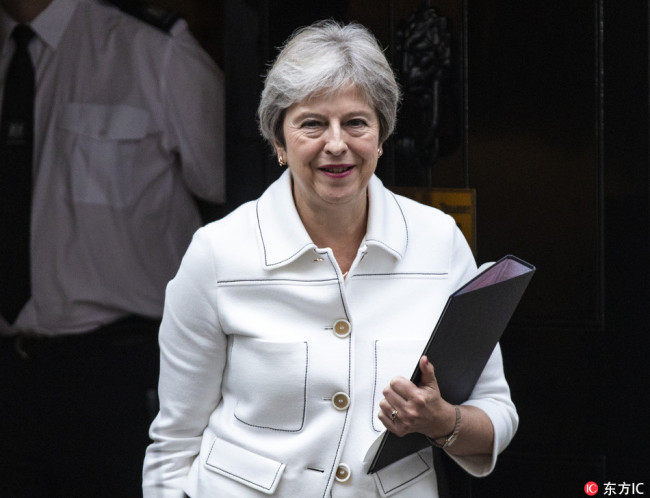 Prime Minister Theresa May leaves 10 Downing Street as she heads to Parliament to update MPs on the ongoing Brexit negotiations on October 15, 2018. [Photo: IC]  