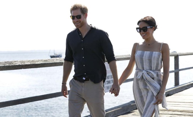 Britain's Prince Harry, left, and Meghan, Duchess of Sussex walk along Kingfisher Bay Jetty during a visit to Fraser Island, Australia, Monday, Oct. 22, 2018. Prince Harry and his wife Meghan are on day seven of their 16-day tour of Australia and the South Pacific. [Photo: AP]