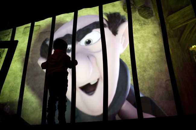 A child watches Smurfs character Gargamel being displayed in a virtual projection during the Smurfs exhibition marking the 60th anniversary of their creation by Belgium cartoonist Pierre Culliford, known as Peyo, in Brussels, Tuesday, Oct. 23, 2018.[Photo: AP]