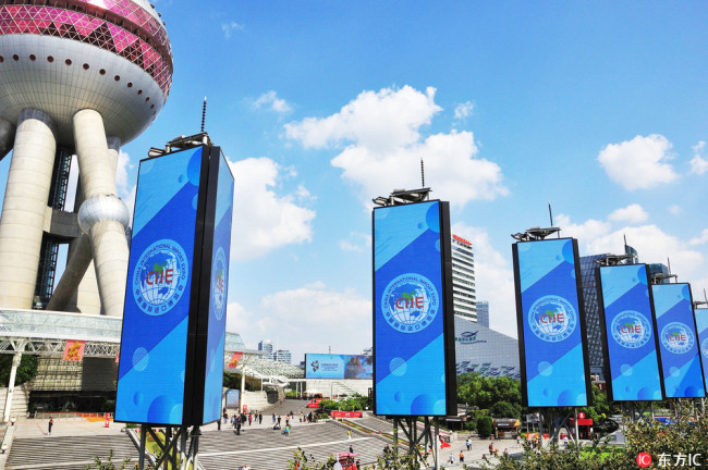 Signboards of the China International Import Expo (CIIE) are seen in front of the Oriental Pearl TV Tower at the Lujiazui Financial District in Pudong in Shanghai, China, 11 October 2018.[Photo:IC]