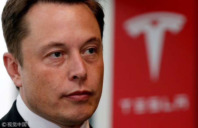  Tesla Motors Inc Chief Executive Elon Musk pauses during a news conference in Tokyo, Japan, September 8, 2014. [Photo: VCG]