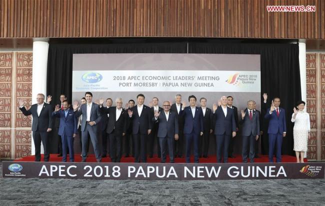 Chinese President Xi Jinping (5th L, front) and other leaders and representatives from member economies of the Asia Pacific Economic Cooperation (APEC) pose for a group photo before the 26th APEC Economic Leaders' Meeting in Port Moresby, Papua New Guinea, on Nov. 18, 2018. [Photo: Xinhua/Ding Lin]