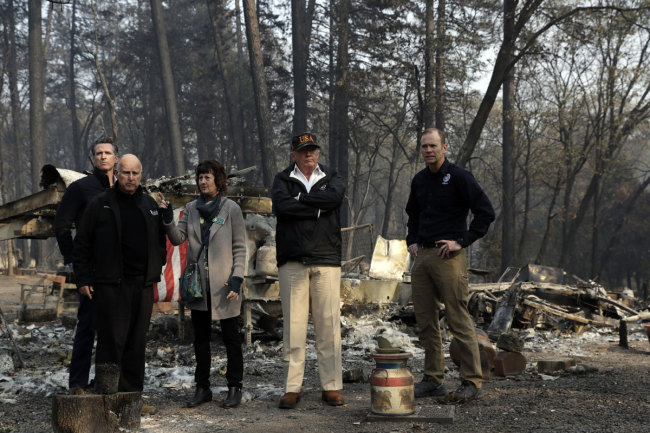 President Donald Trump surveys burned homes as he tours Paradise, Calif., with Gov.-elect Gavin Newsom, California Gov. Jerry Brown, Paradise Mayor Jody Jones and FEMA Administrator Brock Long, right, during a visit to a neighborhood impacted by the wildfires, Saturday, Nov. 17, 2018, in Paradise, Calif. [Photo: AP/Evan Vucci]