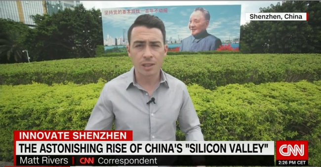 Matt Rivers stands in front of a painting of Deng Xiaoping, former Chinese leader who initiated reform and opening-up policies. [Screenshot: China Plus]