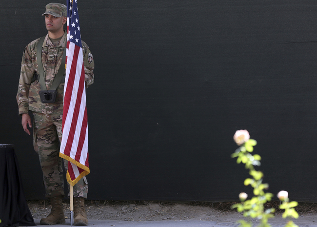 A U.S. Army soldier holds a flag during the change of command ceremony at Resolute Support headquarters, in Kabul, Afghanistan, Sunday, Sept. 2, 2018. [File Photo: AP/Massoud Hossaini]