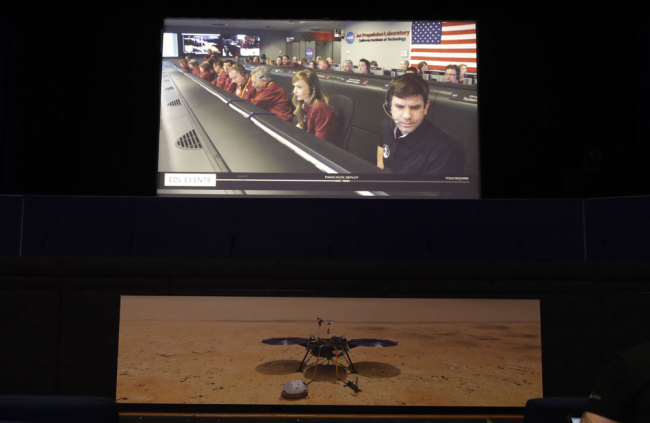 A video feed of the InSight lander mission control room is seen at NASA's Jet Propulsion Laboratory Monday, Nov. 26, 2018, in Pasadena, Calif. The NASA InSight lander arrived successfully on Mars' surface. [Photo: AP/Marcio Jose Sanchez]